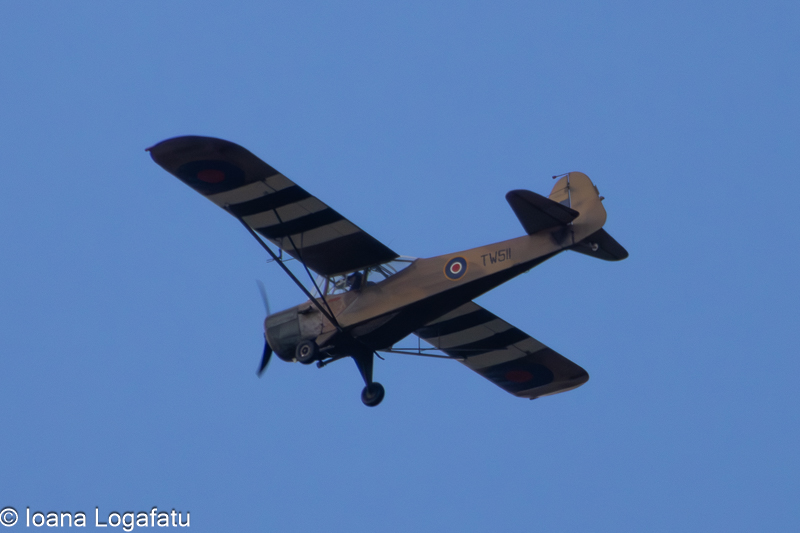 Vintage aircraft soaring through a clear sky